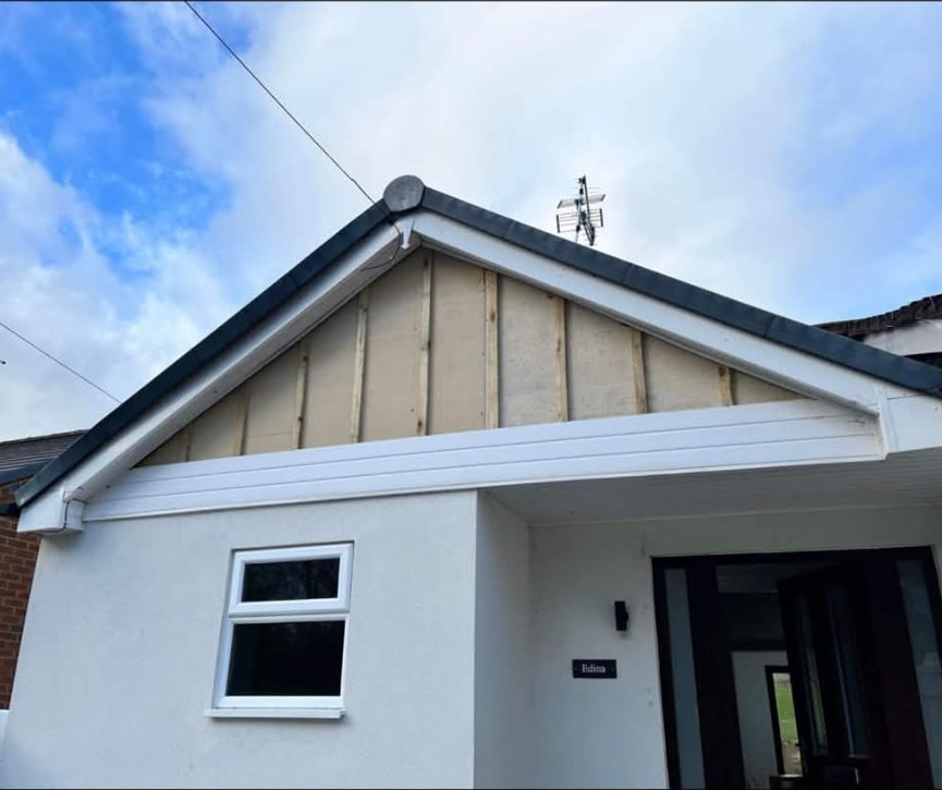 Gable end uPVC cladding before work — Northwich area